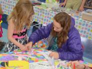 Mother helps her daughter with an easter craft