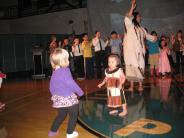 A young audience member joins the invitational dance
