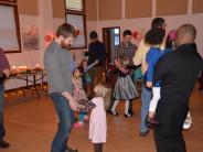 Fathers and their daughters enjoy a dance.
