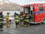 Fire and EMS volunteers load a "victim" from a downed plane into an ambulance
