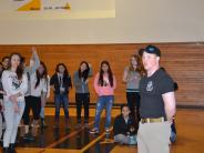 Officer Haskins instructs high school seniors on personal safety