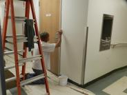 Facilities Maintenance employee painting.