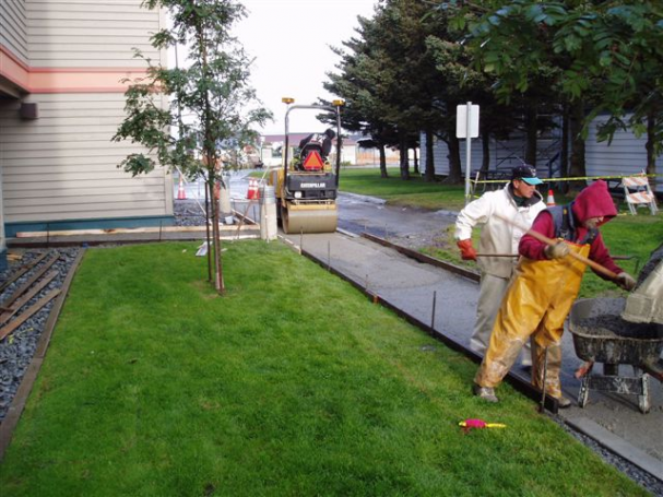 Facilities Maintenance staff working on the sidewalk